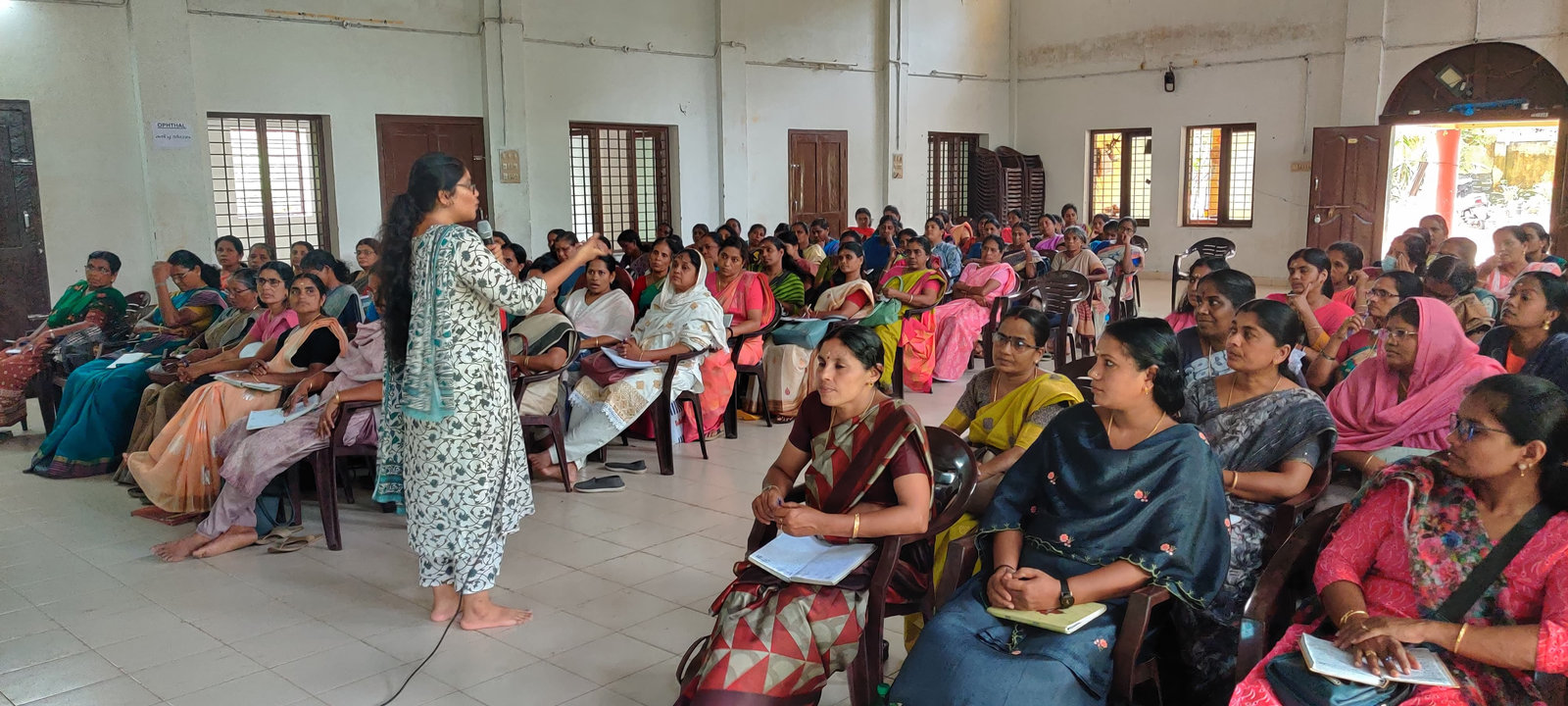 A trainer speaking to a hall full of Anganwadi teachers in Attappady