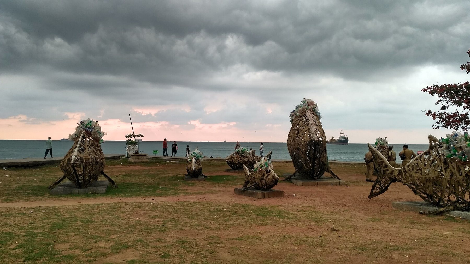Biennale installations on Fort Kochi beach under a monsoon sky