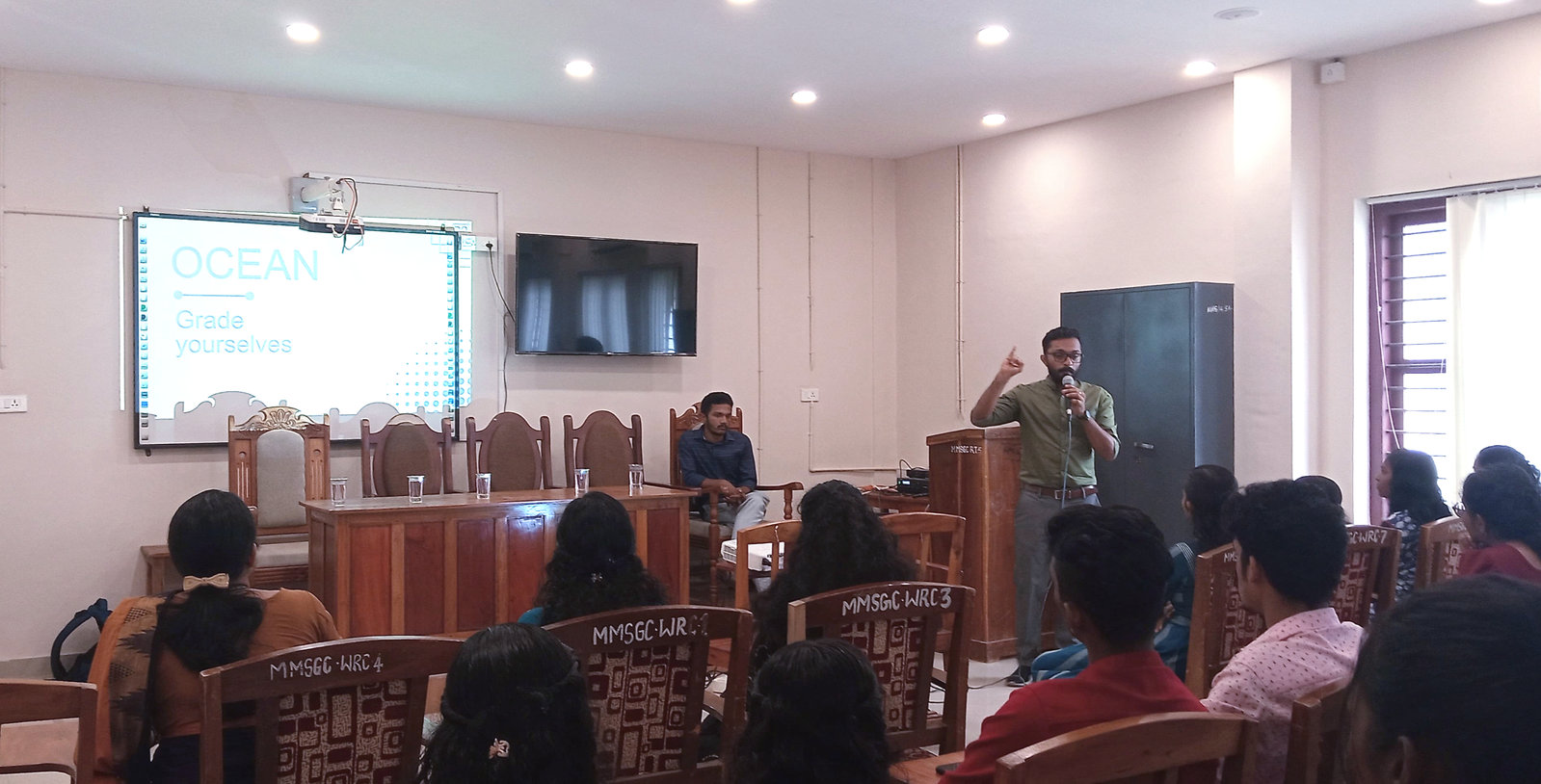Students listen to a DISHA facilitator