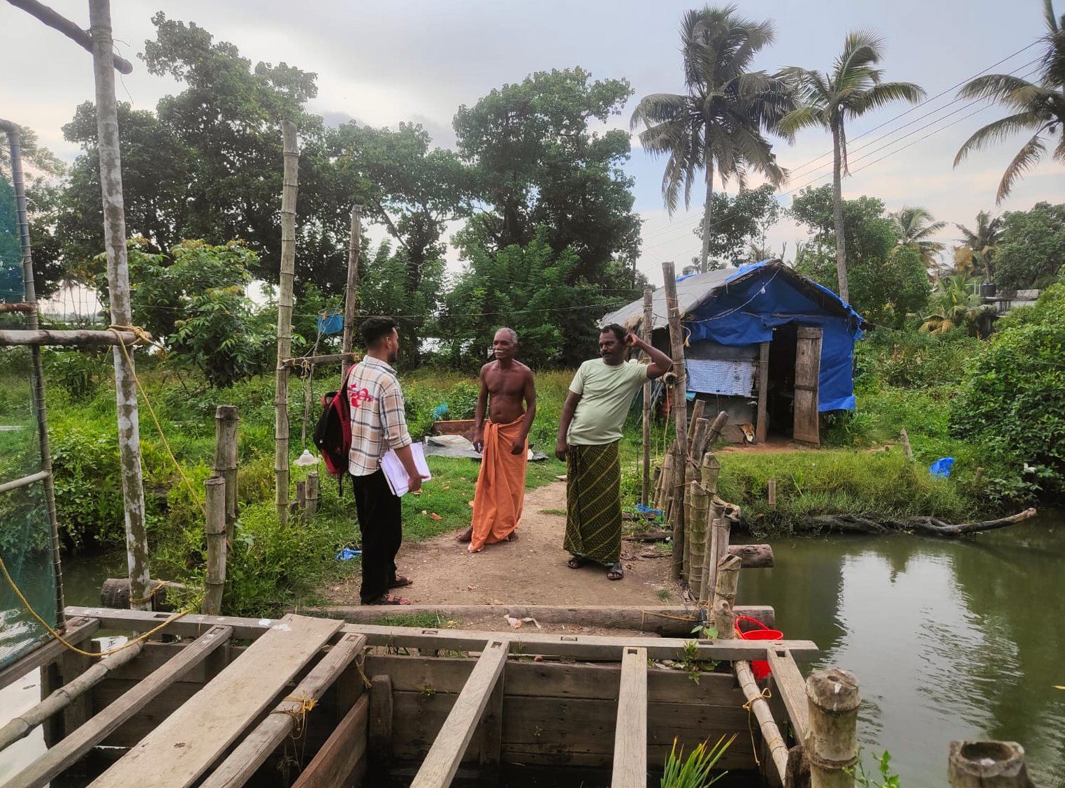 Researchers with residents beside the backwaters on Lanka Thuruth
